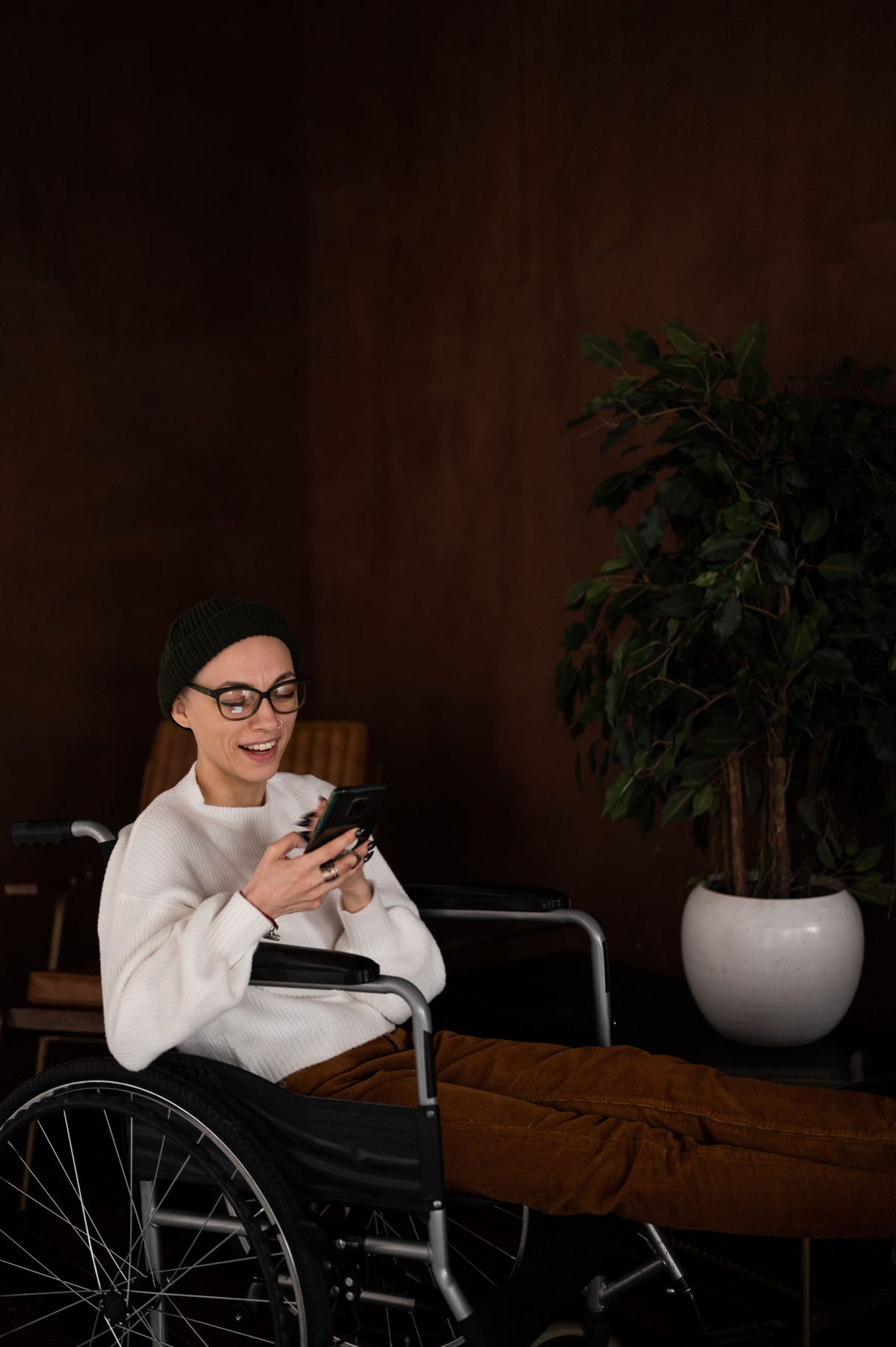 Woman using a wheelchair and smartphone